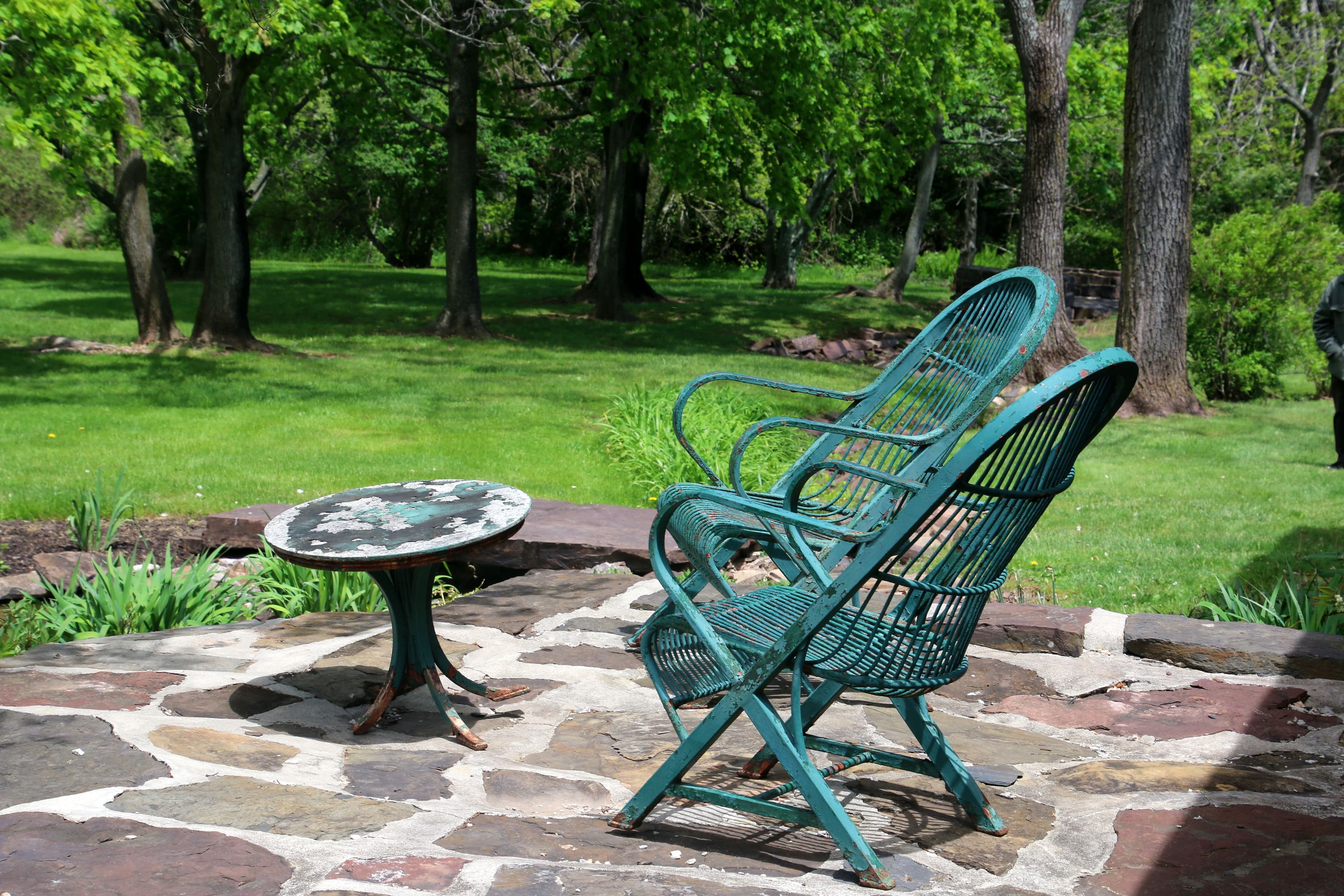 Outdoor seating surrounded by a lush garden and flowering plants